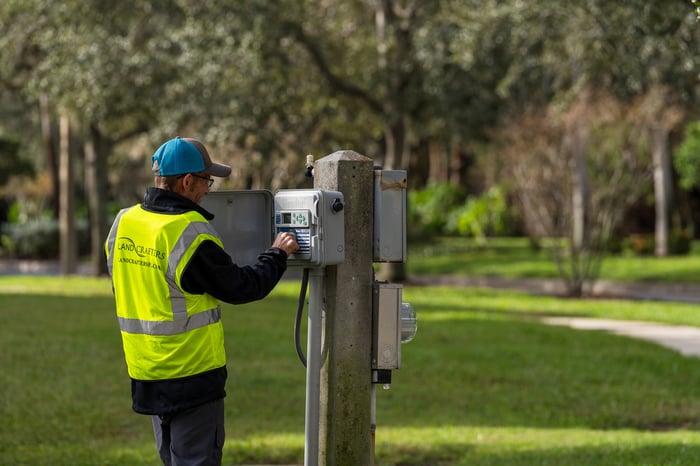 Crew adjusting irrigation controls 