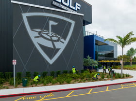 Top Golf commercial landcape crew cleaning up flower beds