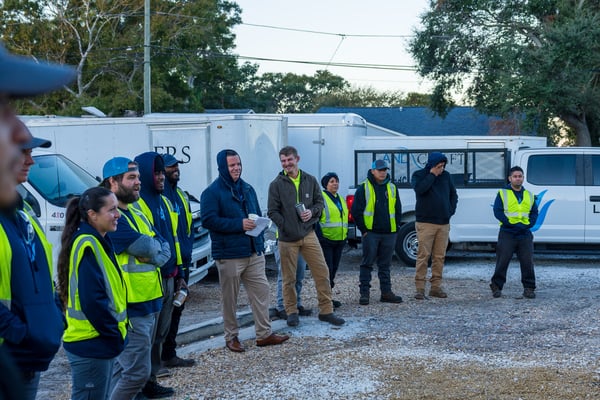 crew in yard for morning meeting 