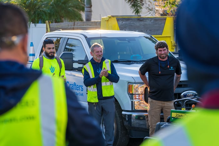 crew in yard for morning meeting 7