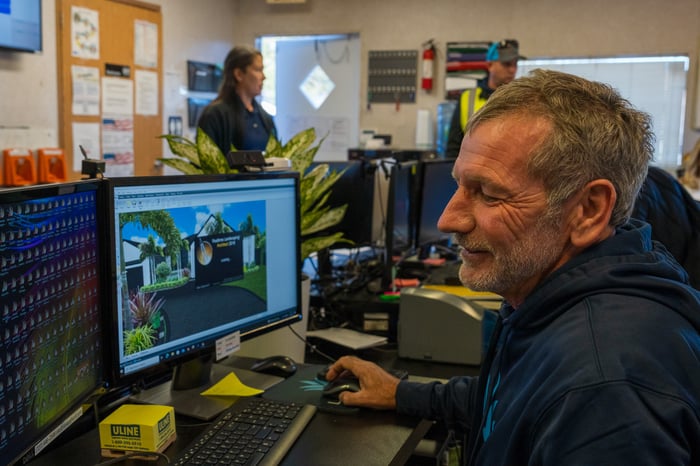 crew looking at computer in office 